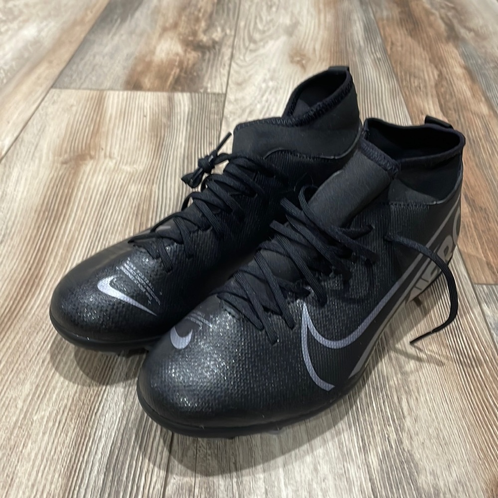 Nike soccer shoes. All black. With DSG long socks and adidas knee pads. 6Y